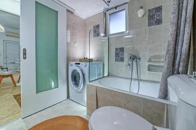 a bathroom with a washing machine and a sink at Hope apt - 5min to Falassarna Bch in Kissamos
