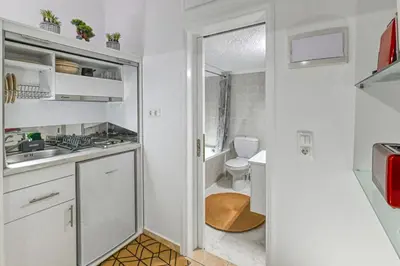 a small white kitchen with a sink and a toilet at Hope apt - 5min to Falassarna Bch in Kissamos