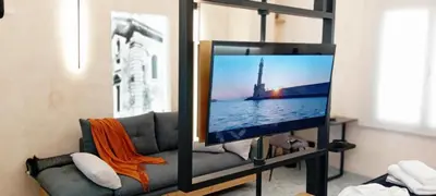 a living room with a tv and a couch at Domus Vivendi in Chania Town