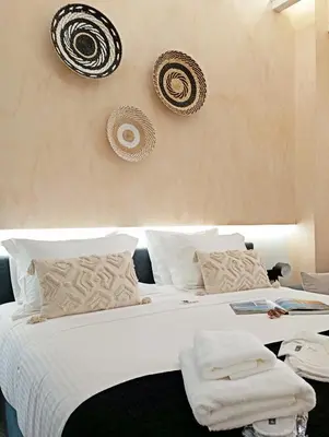 a bedroom with a large bed with white sheets and pillows at Domus Vivendi in Chania Town