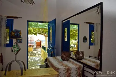 a mirror on the wall of a room with a table at Vrachos Apartments in Frangokastello