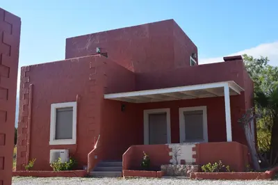 a red brick house with stairs in front of it at Pasithea in Frangokastello