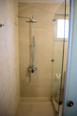 a bathroom with a shower with a glass door at Pasithea in Frangokastello