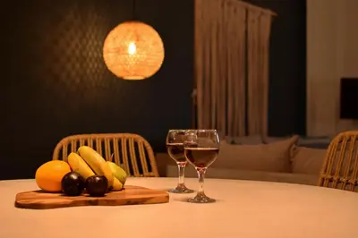 a table with two glasses of wine and fruit on it at Pasithea in Frangokastello