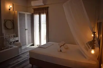 a bedroom with a white bed with a window at Pasithea in Frangokastello