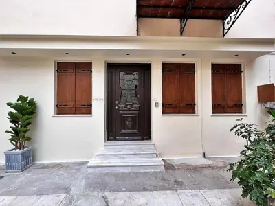 a front door of a house with wooden doors at Talos Too, Venetian Residence in Chania Town