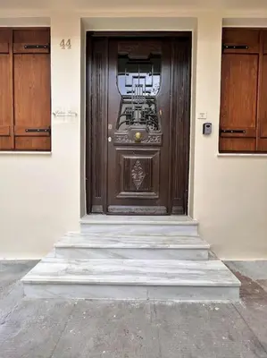 a wooden door on the side of a building at Talos Too, Venetian Residence in Chania Town