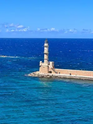 a lighthouse on a island in the middle of the ocean at Talos Too, Venetian Residence in Chania Town