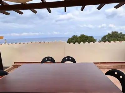 a table in front of a fence with a table with eyes at Talos Too, Venetian Residence in Chania Town