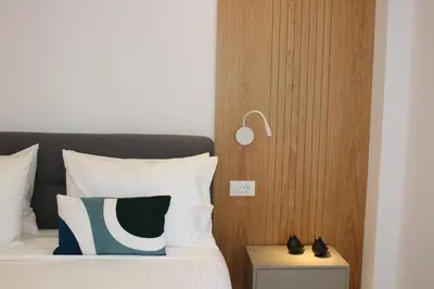 a bedroom with a bed with a lamp on it at Camelia Home in Chania Town
