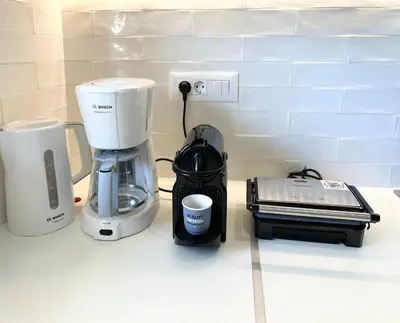 a coffeemaker and a coffee maker on a counter at Camelia Home in Chania Town