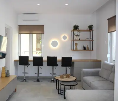 a living room with a couch and a table and chairs at Camelia Home in Chania Town