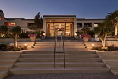 a staircase in front of a building with lights at Atlantica Kalliston Resort - Adults Only in Stalos