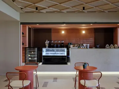 a kitchen with two tables and chairs in a room at Atlantica Kalliston Resort - Adults Only in Stalos