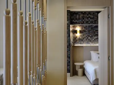 a door leading to a bedroom with a bed at Atlantica Kalliston Resort - Adults Only in Stalos
