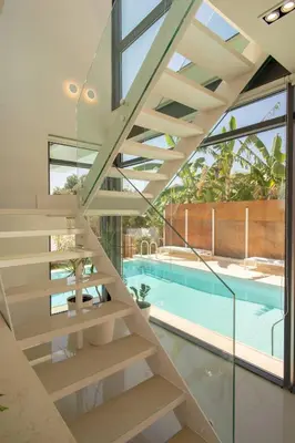 a staircase leading to the pool in a house at Luxury Villa Mirror - 200meters From The Beach in Daratso