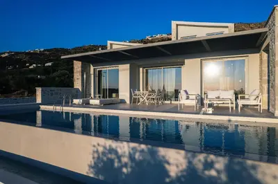 a house with a swimming pool next to a house at Petras Luxury Villas in Falasarna