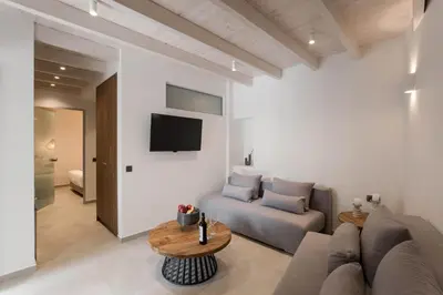 a living room with a couch and a table at Evge Experience Boutique Hotel in Kafoúros