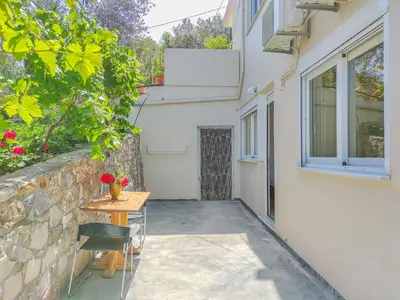 a small table and chairs next to a building at Fully renovated Studio in Platanias in Plataniás