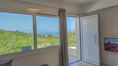 a room with a window with a view of the ocean at Fully renovated apartment in Platanias 1 in Plataniás