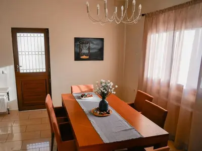 a dining room table with a vase of flowers on it at Giovanni City House near Chania City Center in Chania Town