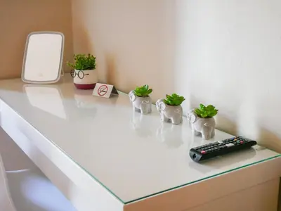 a table with three plants and a remote control on it at Giovanni City House near Chania City Center in Chania Town