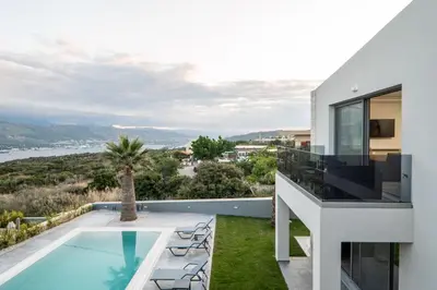 a villa with a swimming pool and a house at Jarko Luxury Houses in Argoulidhés