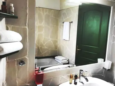 a bathroom with a sink and a green door at VILLA IRIS in Vryses