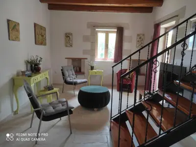 a living room with a spiral staircase and chairs at VILLA IRIS in Vryses