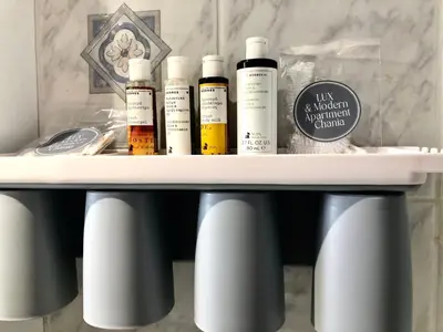a shelf with four bottles of essential oils on a sink at Lux and modern apartment Chania in Chania Town