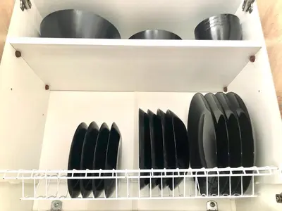 a white shelf with black plates and pans at Lux and modern apartment Chania in Chania Town