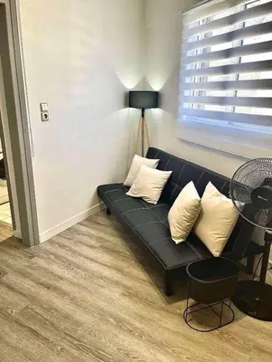 a living room with a black couch and a table at Lux and modern apartment Chania in Chania Town
