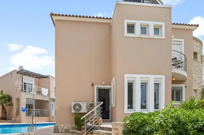 a villa with a swimming pool in a resort at Villa Blue Dreams in Maleme in Ayiá