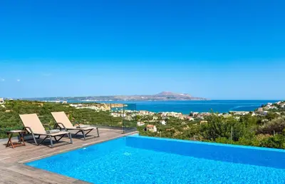 a villa with a swimming pool and a view at Villa Vereniki in Áyios Andhréas
