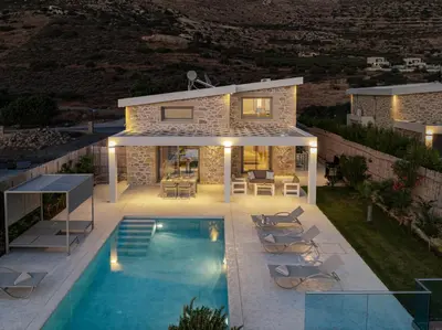 a villa with a swimming pool in front of a house at ALKI VILLAS COLLECTION -LUXURY SEA VIEW VILLAS - BREAKFAST INCLUDED- Falasarna in Falasarna