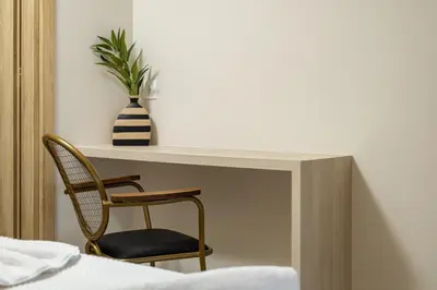 a desk with a chair and a vase with a plant at ALKI VILLAS COLLECTION -LUXURY SEA VIEW VILLAS - BREAKFAST INCLUDED- Falasarna in Falasarna