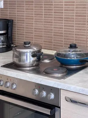 two pots and pans sitting on top of a stove at KOSTAS HOUSE in Chania Town