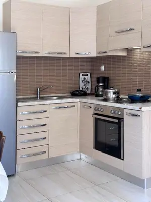 a kitchen with a stove and a refrigerator at KOSTAS HOUSE in Chania Town