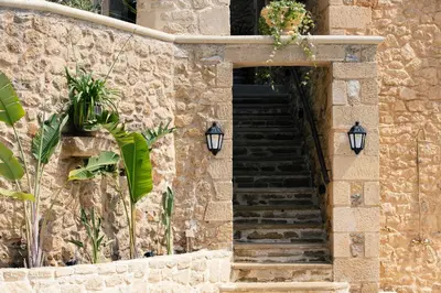 a stone building with stairs and lights on it at Kotinos Luxury Villa in Chania Town