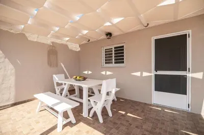 a dining room with a white table and chairs at Serenitas, family house with great views in Sfakiá