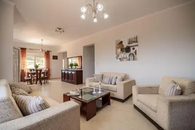 a living room with two couches and a table at Serenitas, family house with great views in Sfakiá
