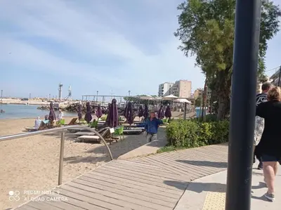 a group of people walking on a beach at Omiros Apartment in Chania Town