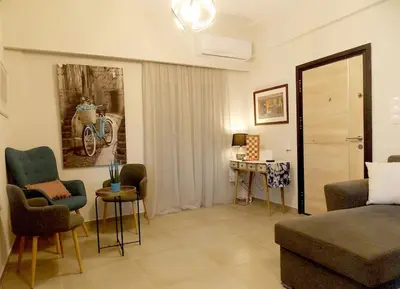 a living room with a couch and chairs in a room at Alena home in Chania Town