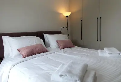 a large white bed with towels on top of it at Alena home in Chania Town