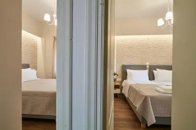 a hotel room with two beds and a mirror at Luxurious house near the sea in Kato Daratso