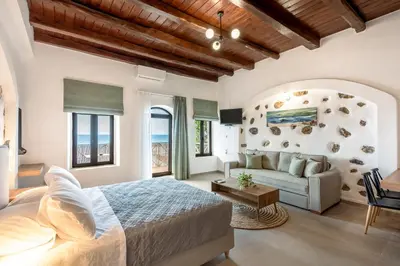 a bedroom with a bed and a couch at Superb apartmentS Kriaras sea view in Sfakia in Khóra Sfakíon