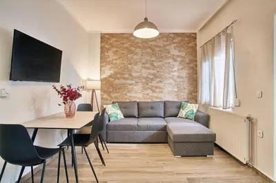a living room with a couch and a table at Lux and Cozy in Kato Daratso