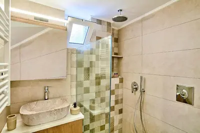 a bathroom with a sink and a shower at Lux and Cozy in Kato Daratso