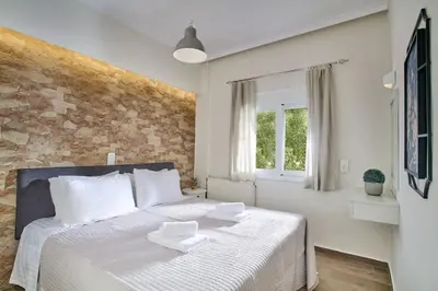 a bedroom with a bed with two white dishes on it at Lux and Cozy in Kato Daratso