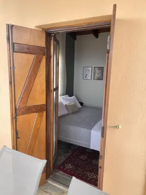 a door leading to a bedroom with a bed at almond home in Livadia